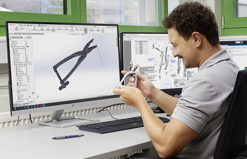 Design engineer at Erchinger checking a surgical instrument against the CAD design — development