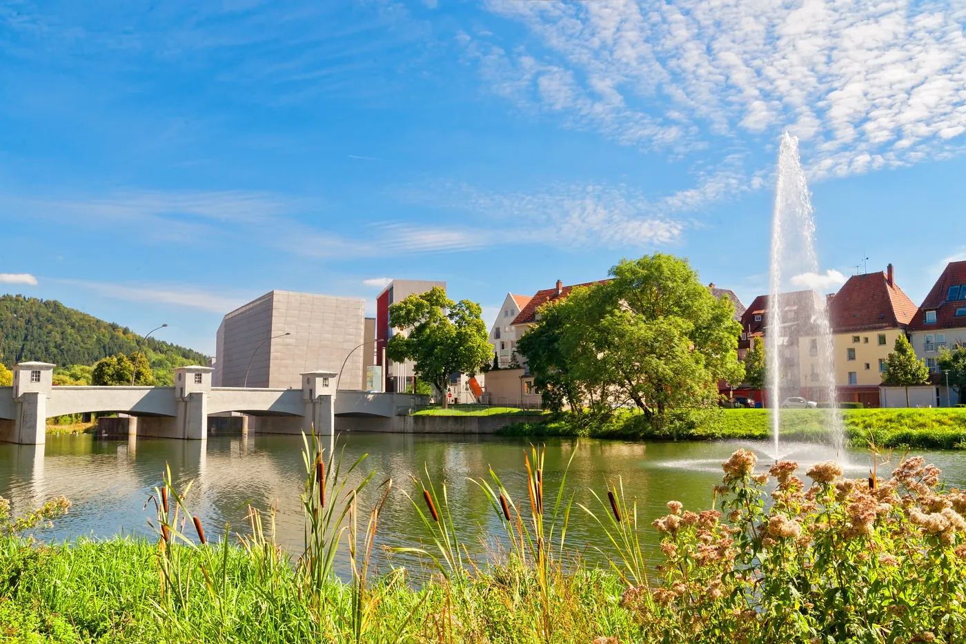 The river Danube in the centre of Tuttlingen with fountain, bridge and townscape in summer