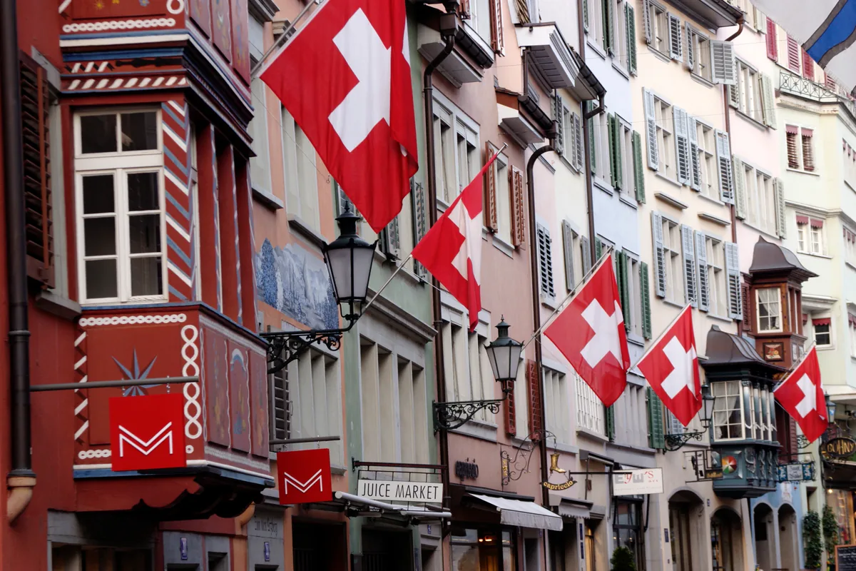 A street in Zurich old town lined with Swiss flags